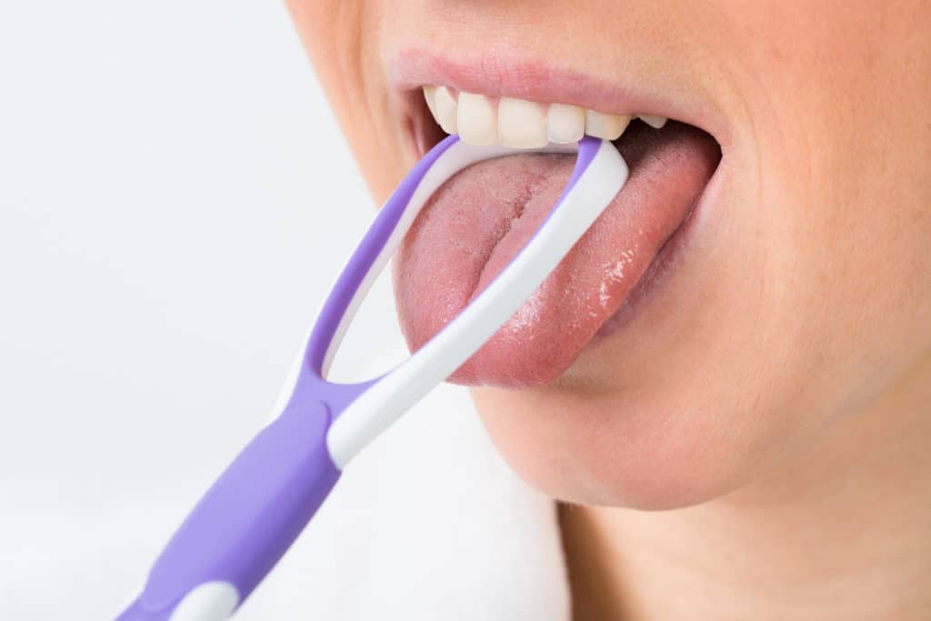 Clean Your Tongue While Brushing Your Teeth Featured Image - Bowen Family Dentistry